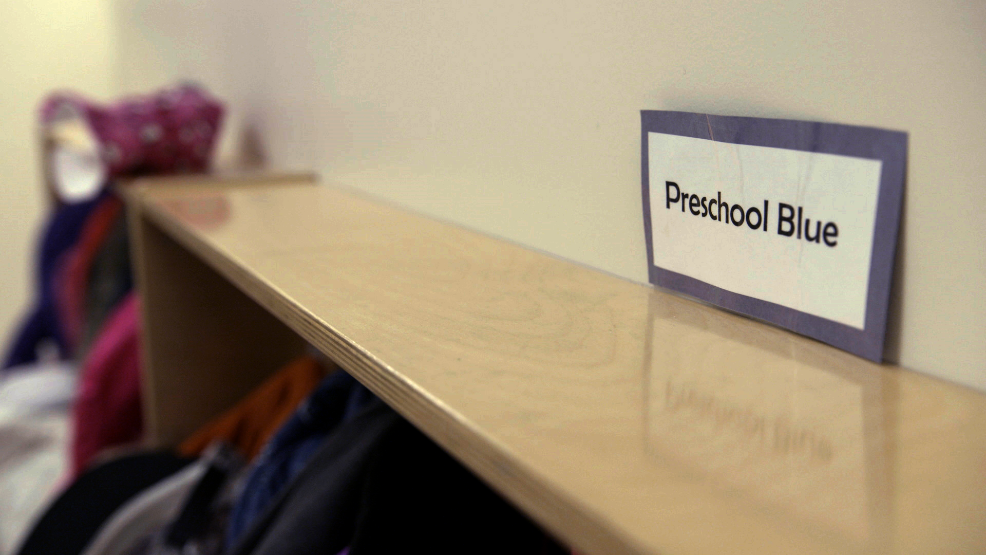 Close-up of a shelf with a sign reading 