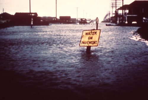 Flooded street with a sign reading 