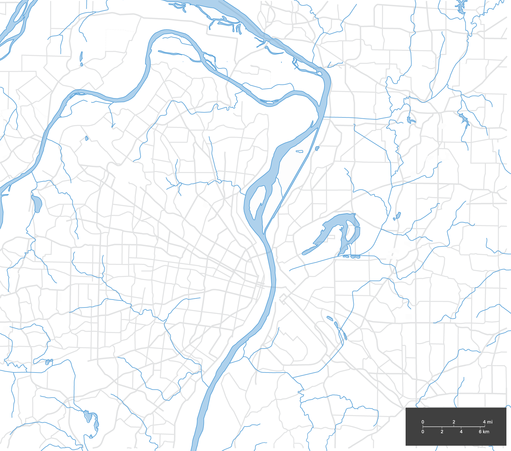 Map highlighting waterways with rivers and streams in blue, overlaid with a city street grid in grey.
