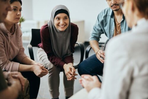 Group sitting down talking enthusiastically.