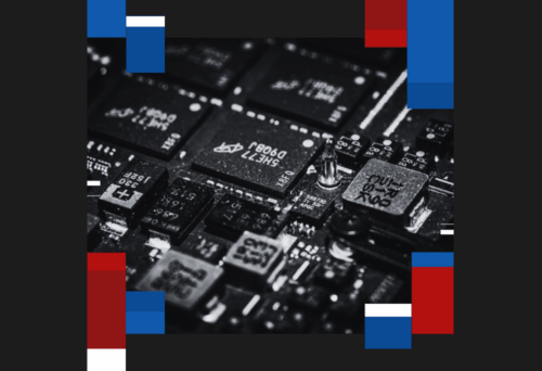 Close-up of a printed circuit board with microchips and blue, red, and white colored borders.