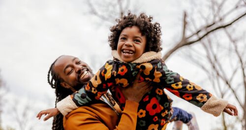 A father lifting his child up into the air