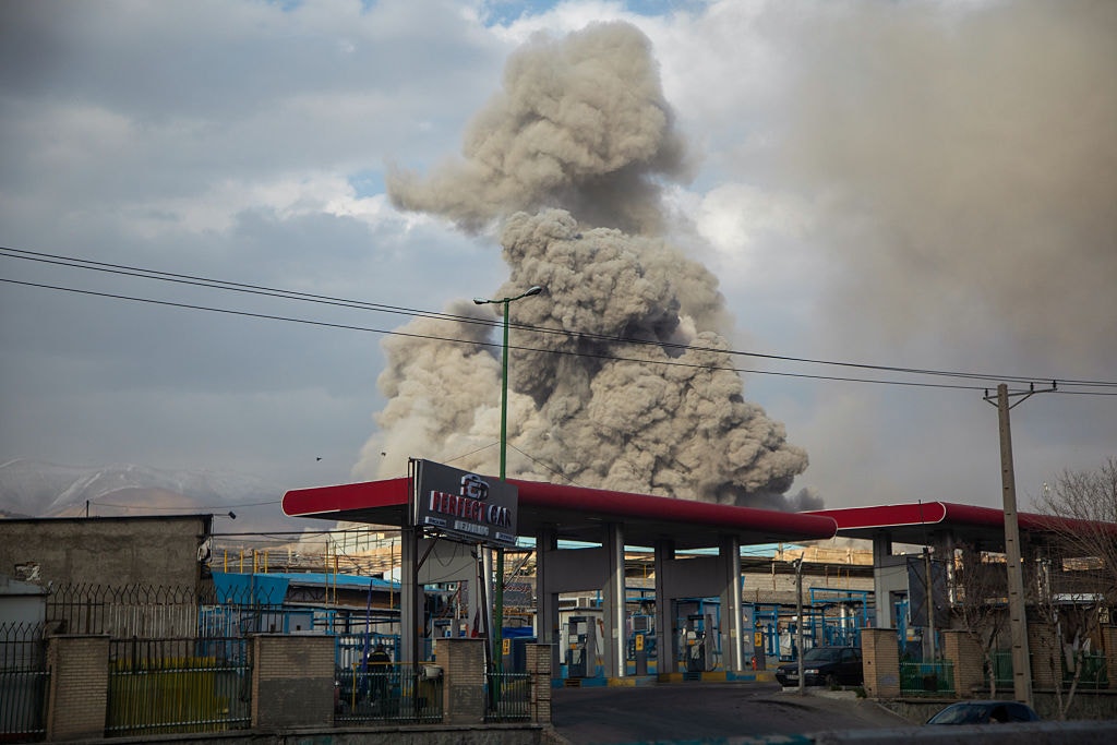 A plume of smoke rises after an explosion