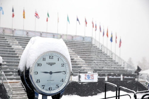 Snow falls over clock.