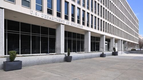 A wide shot of a gray building that says 