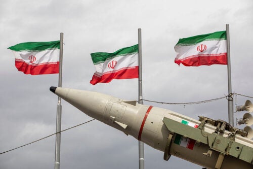 Missiles produced by Iran's armed forces are displayed near a row of Iranian flags during commemorations to mark the anniversary of the 1979 Iranian Revolution on February 11, 2026 in Tehran, Iran. In that year, Ruhollah Khomeini led an overthrow of the Pahlavi dynasty in 1979 and established himself as Supreme Leader of the Islamic Republic of Iran.
