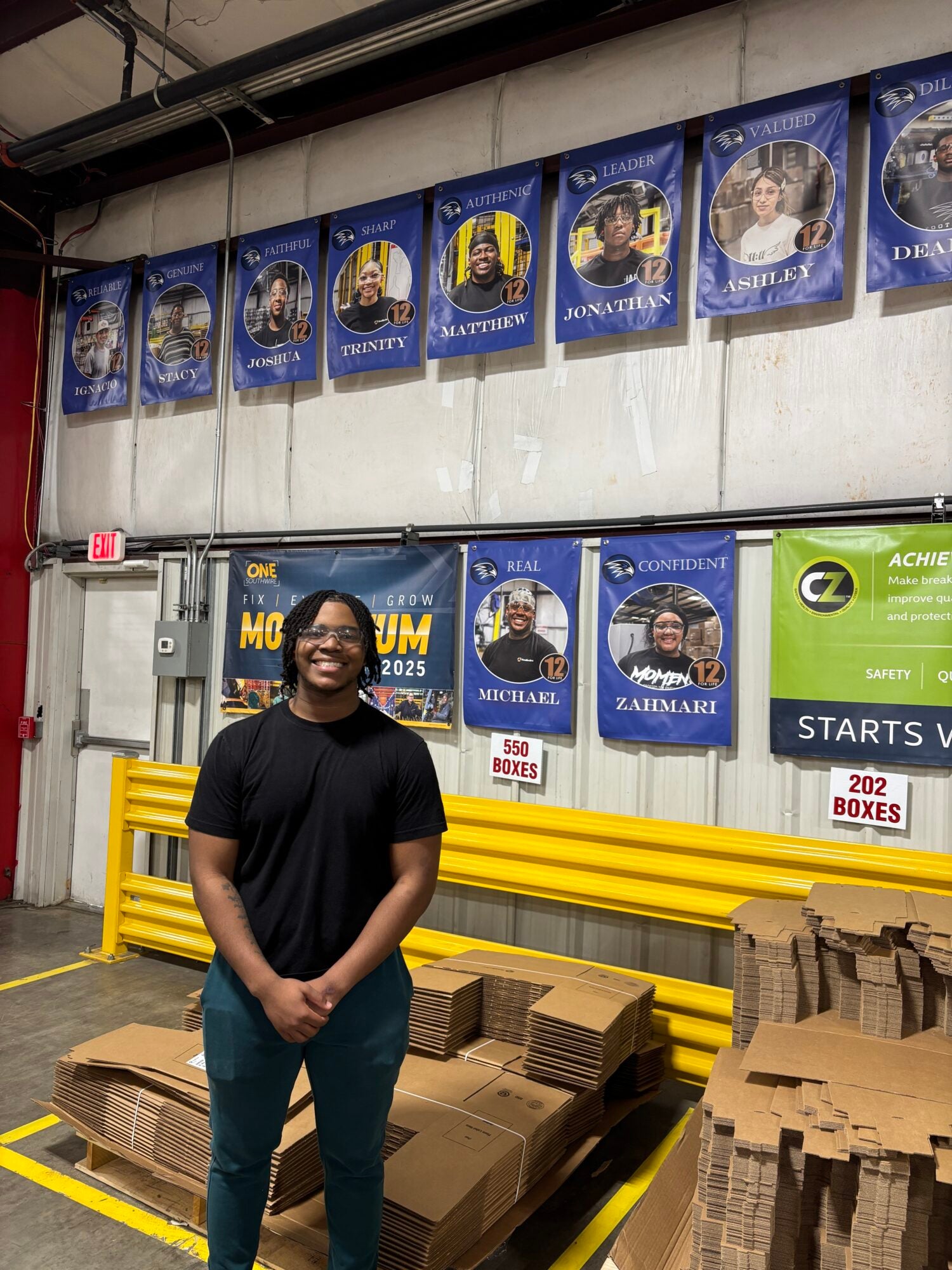 An apprentice stands at an electrical wire manufacturer.