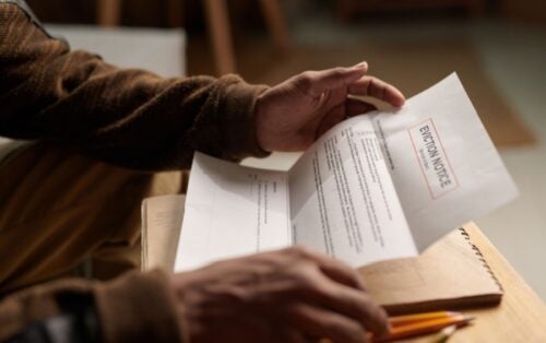 Hands holding a piece of paper.