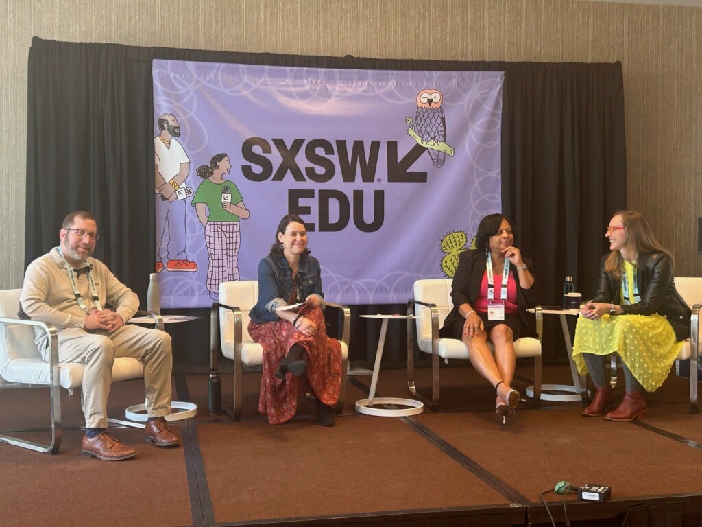 Speakers Elliot Haspel, Vicki Shabo, Charlotte Guinn, and Jen Bradwell sit on a small stage at South by Southwest EDU in front of a purple banner.