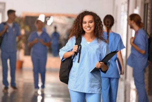 A young healthcare worker in a hallway