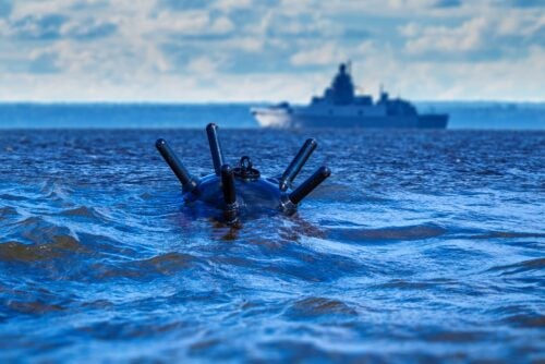 Image of a sea mine and a ship.