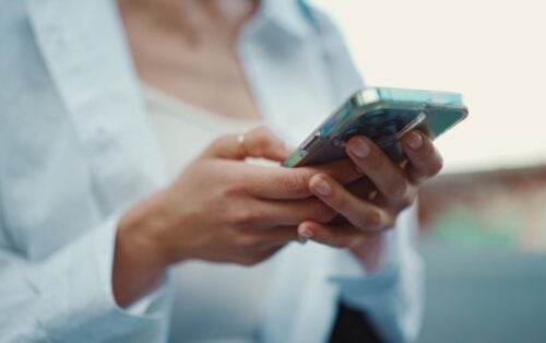 Two hands holding a smart phone and scrolling