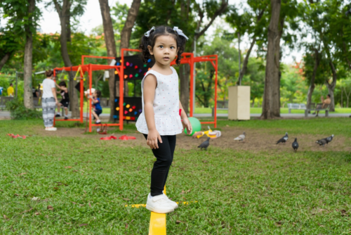 A little girl on a balance beam