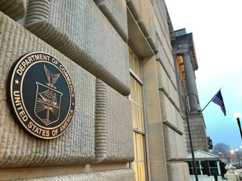 The seal of the US Department of Commerce on the side of a building in Washington, DC.