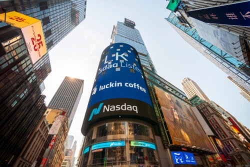 The Nasdaq MarketSite tower in Times Square, New York City, with a large curved LED display visible among surrounding skyscrapers.