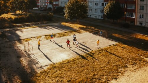 An aerial shot of children playing soccer.