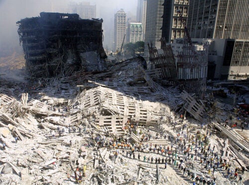 394392 17: Rescue workers sift through the wreckage of the World Trade Center September 13, 2001 in New York City, two days after two hijacked airplanes slammed into the twin towers, levelling them in an alleged terrorist attack. (Photo by Mario Tama/Getty Images)