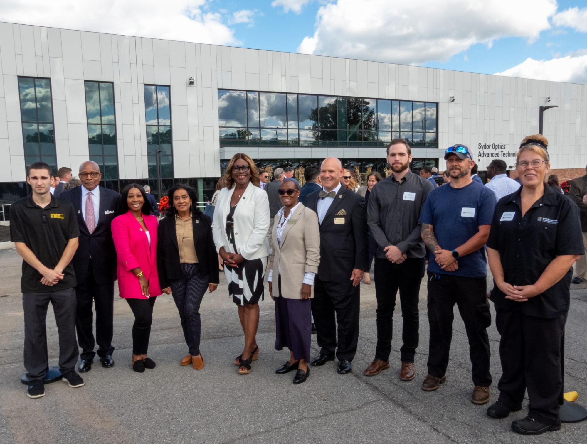 A group of people standing outside of a large building