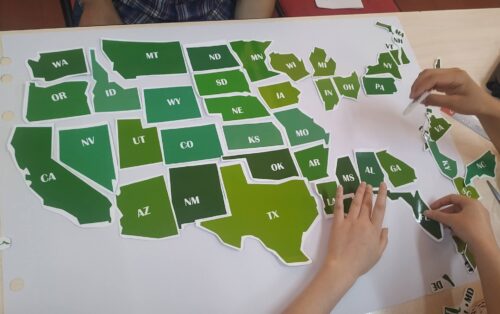 Students puzzling out the US map.